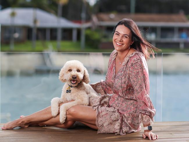 Golden girl of the pool Sam Riley with her dog Sunny. Picture: Nigel Hallett