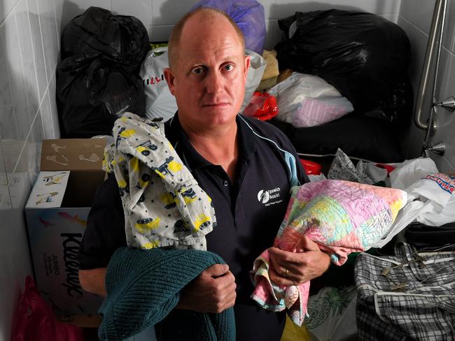 Ipswich Assist manager Jason Budden with blankets donated as part of GIVIT.