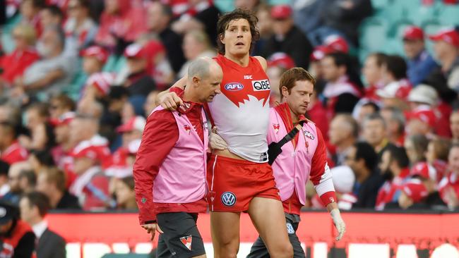 Kurt Tippett is helped off the field after injuring his knee last weekend against Carlton. Picture: AAP