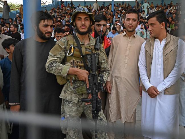 A Taliban fighter stands guard during the Twenty20 cricket trial match between Afghan teams 'Peace Defenders' and 'Peace Heroes' at the Kabul International Cricket Stadium. Picture: AFP