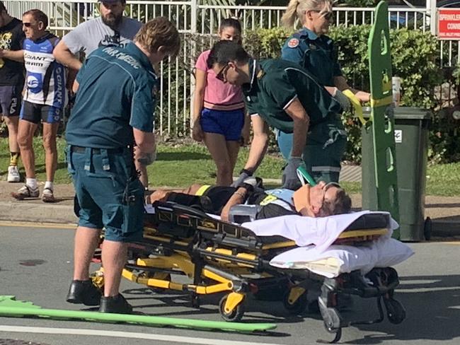 A person is treated by paramedics after a Suzuki car collided with a cyclist  at the corner of Garfield Terrace and Thornton St, beside the Northcliffe Surf Lifesaving Club, Surfers Paradise.