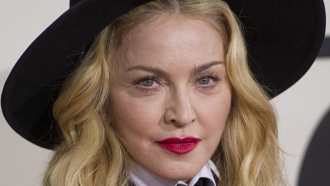 (FILES) In this January 16, 2014 file photo, singer Madonna arrives on the red carpet for the 56th Grammy Awards at the Staples Center in Los Angeles. Madonna on March 2, 2015 announced concerts across North America and Europe to support her new album, her first extensive shows since a high-grossing and controversy-filled global tour in 2012. The pop superstar will start a 35-date tour to accompany her "Rebel Heart" album on August 29 in Miami, with concerts across North America as well as a show in Puerto Rico before she heads to Europe in November. Madonna's last scheduled concert is on December 20 in Glasgow, but a statement from concert promoters said that she would soon announce additional dates in Asia and Australia. AFP PHOTO/ROBYN BECK / FILES