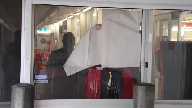 A Coles employee blocks the window at the Alice Spring Coles Tuesday, May 27, 2025. A man has died inside Alice Springs Coles on May 27, 2025, with police saying he was in custody at the time. Picture: Gera Kazakov