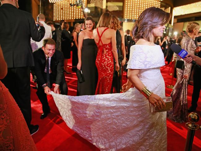 Karl Stefanovic bends down to adjust the dress of Lisa Wilkinson as she arrives at the 2015 Annual Logie Awards. Picture: Getty