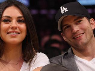 Ashton Kutcher and Mila Kunis are all smiles as they hang out at the Los Angeles Lakers Vs The Phoenix Suns at the Staples Center in Los Angeles, CA. Picture: Splash News