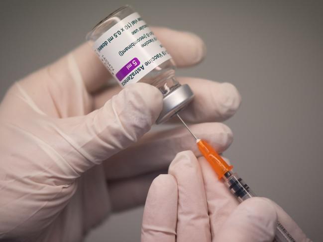 A pharmacist prepares a dose of the AstraZeneca Covid-19 vaccine with a syringe in a pharmacy in Nantes, western France on March 25, 2021. (Photo by LOIC VENANCE / AFP)