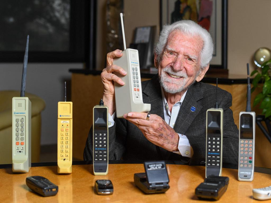 Martin Cooper holds a contemporary copy of the first cell phone. Picture: Valerie Macon/AFP