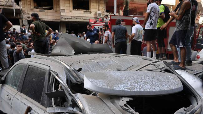 People check the damage following the Israeli strike in Beirut's southern suburbs that killed Ibrahim Aqil and other Hezbollah commanders. Picture: AFP.