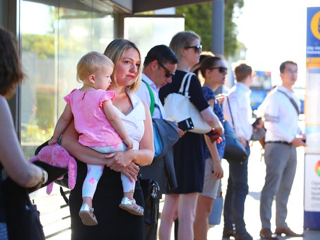 Rachel Cannell with daughter Grace at a severely congested bus stop in morning peak hour.