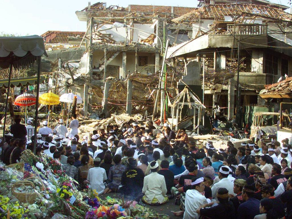 Local Balinese offer prayers during a cleansing ceremony for the victims at the site of the bomb blast in Kuta, Bali in 2002.