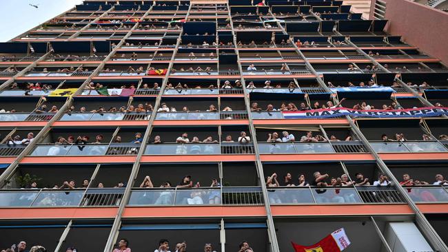 Spectators watch the Formula One Monaco Grand Prix from balconies at the Circuit de Monaco. (Photo by Andrej ISAKOVIC / AFP)