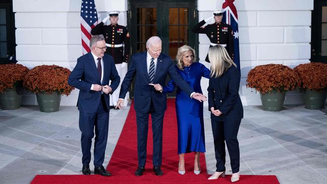 US President Joe Biden (3rd R), First Lady Jill Biden (2nd R) show Jodie Haydon (R) her position as Australia's Prime Minister Anthony Albanese (L) looks on before they pose for pictures at the South Portico of the White House.