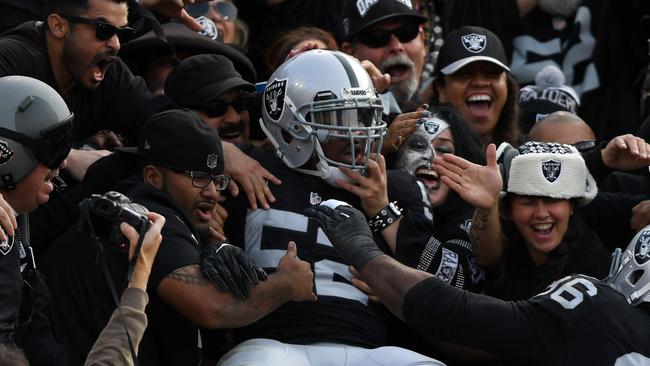 Khalil Mack #52 of the Oakland Raiders celebrates in the stands.