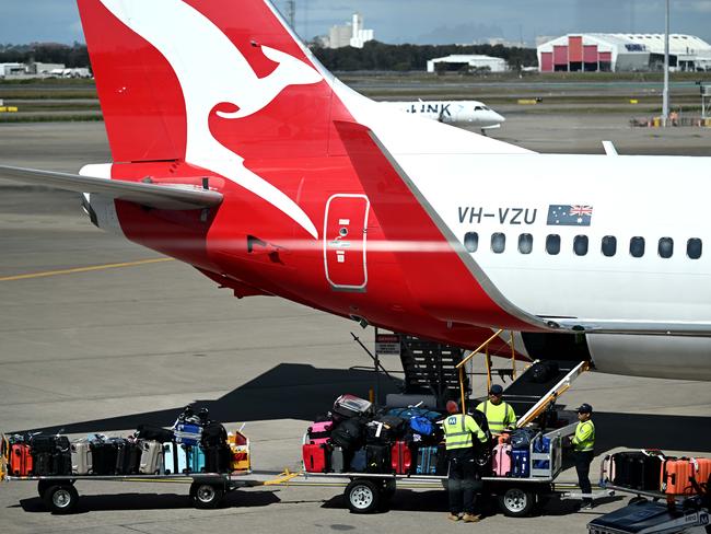 BRISBANE, AUSTRALIA - NewsWire Photos - AUGUST 11, 2022. Qantas baggage handlers at work at Brisbane airport. Industrial action will start at Qantas and budget offshoot Jetstar by the end of August amid an escalating fight over pay with its licensed engineers.Picture: NCA NewsWire / Dan Peled