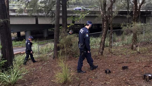 Homicide detectives investigate the area after a body was found covered by the side of the road in Homebush late last night. Picture: Mark Reddie / ABC News