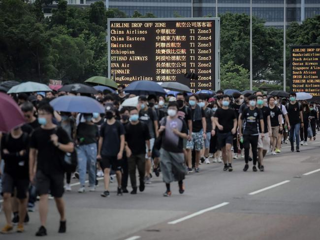 Protesters walk on a highway near Hong Kong's international airport. Picture: Vivek Prakash/AFP