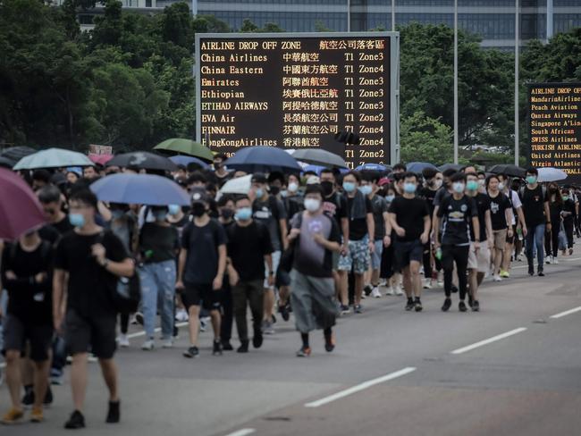 Protesters walk on a highway near Hong Kong's international airport. Picture: Vivek Prakash/AFP