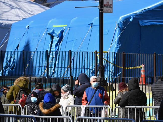 People stand in line to get tested for the coronavirus at a hospital in New York. Cases across the city continued to grow. Picture: AFP