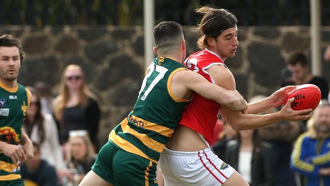 Michael Romano of Parkside is tackled by North Brunswick’s Davor Lucevic. Picture: Hamish Blair