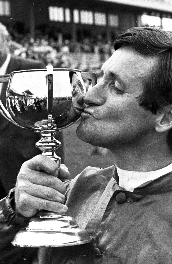 Melbourne Cup jockey Pat Hyland kisses the trophy after winning on racehorse What A Nuisance in 1985.