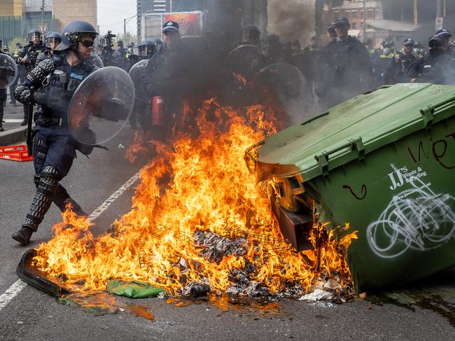 Anti-war activists protest the Land Forces 2024 International Land Defence Exposition at the Melbourne Convention and Exhibition Centre. Protesters set bins on fire before clashing with police on the Clarendon Street Bridge. Picture: Jake Nowakowski