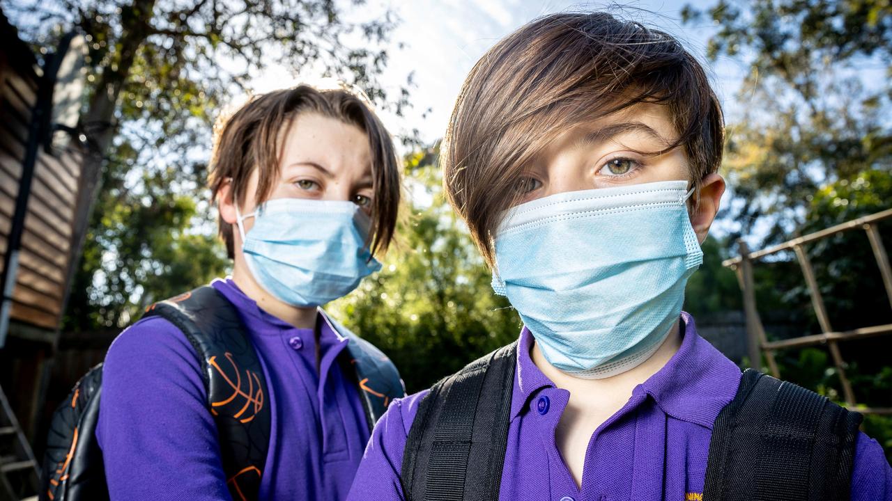 Felix, 12 and Oliver, 9 wear masks to school. Picture: Jake Nowakowski