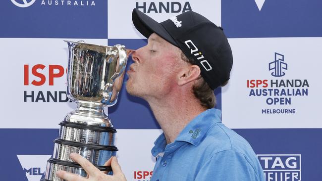 Little-known Ryggs Johnston of the US kisses the Stonehaven Cup after winning the Australian Open. Picture: Darrian Traynor/Getty Images