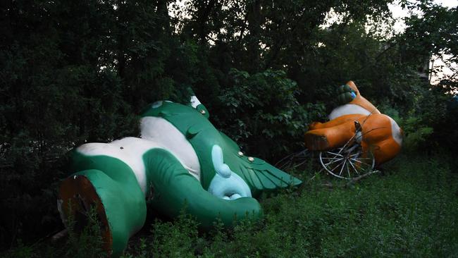 Beijing Olympic mascots Nini and Yingying lying among trees, abandoned in the wake of the 2008 Games. Picture: AFP