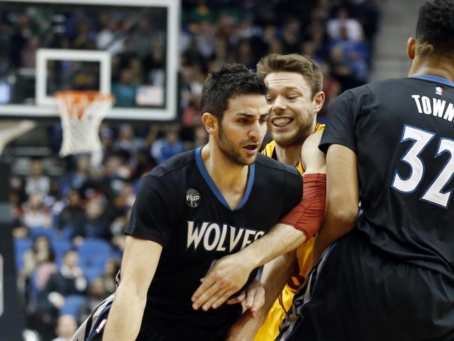 Minnesota’s Ricky Rubio pushes past Matthew Dellavedova.