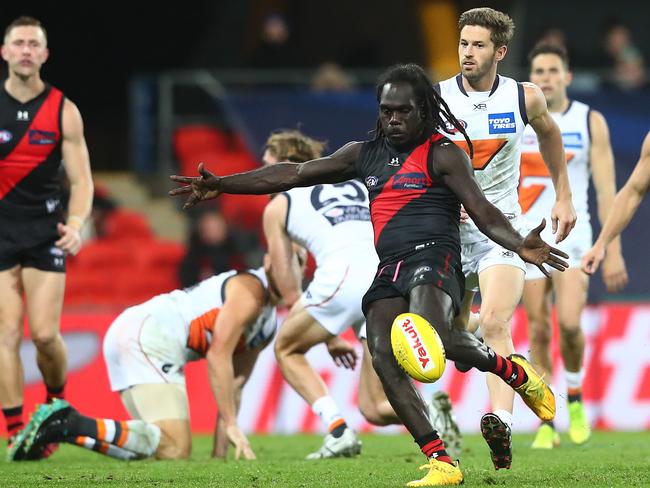 GOLD COAST, AUSTRALIA - AUGUST 07: Anthony McDonald-Tipungwuti of the Bombers kicks during the round 10 AFL match between the Essendon Bombers and the Greater Western Sydney Giants at Metricon Stadium on August 07, 2020 in Gold Coast, Australia. (Photo by Chris Hyde/Getty Images)