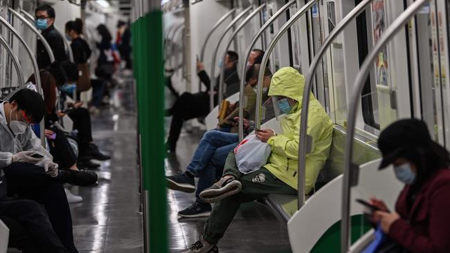 People wearing face masks travel in the subway in Wuhan, in China's central Hubei province Picture: Hector Retamal/ AFP.