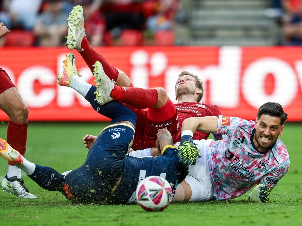 Mariners’ Victor Correia Da Silva heads the ball, with Adelaide United’s Ryan Kitto and goalkeeper James Delianov among the mass of bodies. Picture: Getty Images