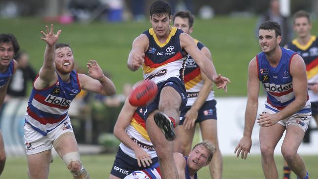 SANFL: Central District v Adelaide at Elizabeth Oval. Crow's Darcy Fogarty kicks toward goal as Central's Jarrod Schiller tries desperately to smother. 15 June 2019. (AAP Image/Dean Martin (AAP).