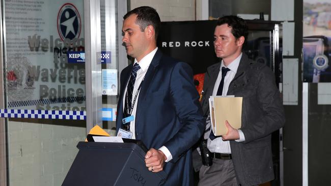 Detective David Murphy (left) outside Waverley Police Station after Mr Day’s arrest. Picture: Bill Hearne