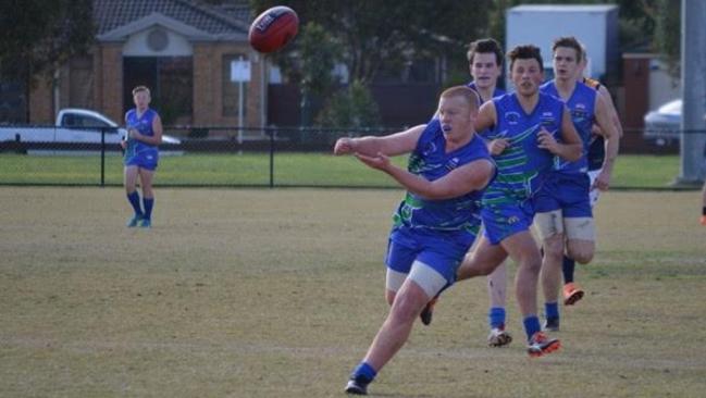 Trent Allison dishes off a handball for Berwick Springs. Picture: Cathy Allison