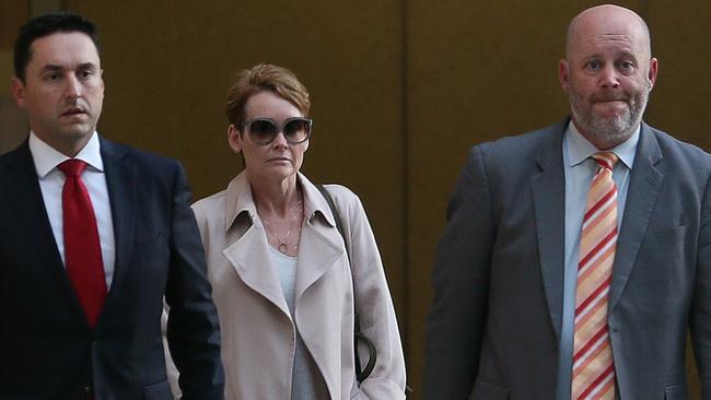 JM Kelly financial controller Elizabeth Murphy leaves Federal Court with her lawyers. (AAP Image - Richard Waugh)