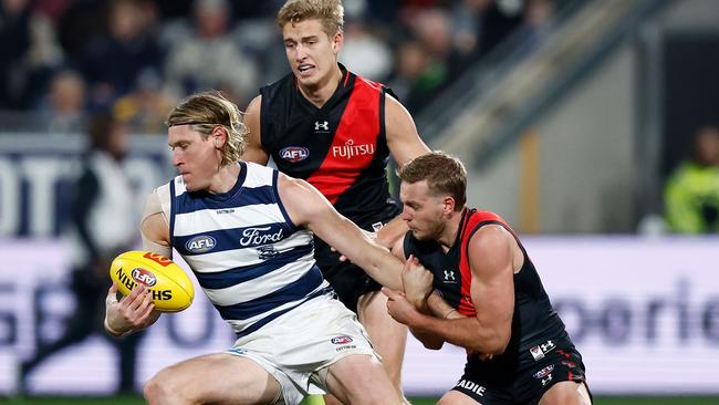 GEELONG, AUSTRALIA - JULY 15: Mark Blicavs of the Cats is tackled by Darcy Parish of the Bombers during the 2023 AFL Round 18 match between the Geelong Cats and the Essendon Bombers at GMHBA Stadium on July 15, 2023 in Geelong, Australia. (Photo by Michael Willson/AFL Photos via Getty Images)