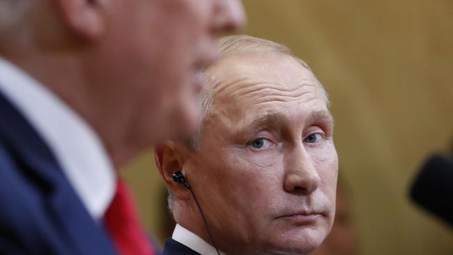 Russian President Vladimir Putin listens to US President Donald Trump during a press conference in Helsinki. Photo: AP
