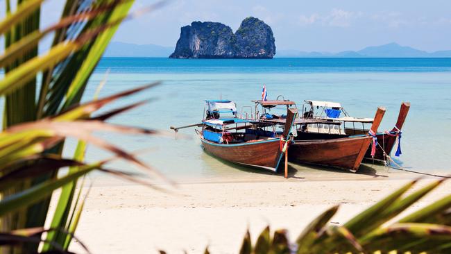 Longtail boats on a beach in Thailand.