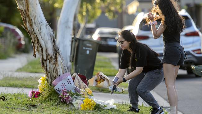 Mourners lay flowers outside the family home. Picture: Jay Town