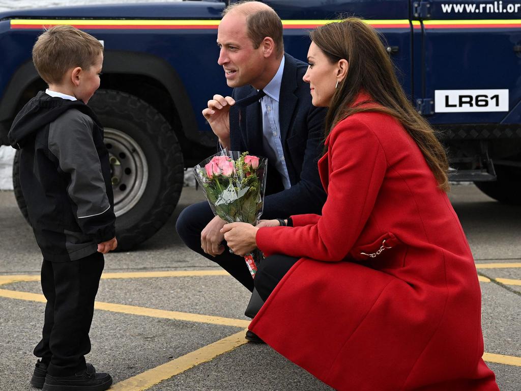 Chatting with Prince William and Kate, Theo Crompton quickly became a favourite among the crowds waiting to welcome the royal couple back to Wales. Picture: AFP