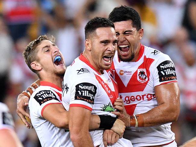 BRISBANE, AUSTRALIA - MARCH 28: Corey Norman of the Dragons is congratulated by team mates after kicking the winning field goal during the round 3 NRL match between the Brisbane Broncos and the St George Illawarra Dragons at Suncorp Stadium at Suncorp Stadium on March 28, 2019 in Brisbane, Australia. (Photo by Bradley Kanaris/Getty Images)