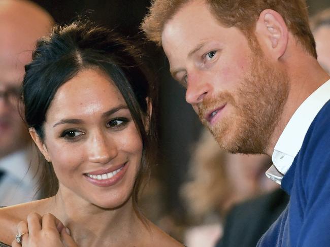 Britain’s Prince Harry talks to Meghan Markle as they watch a dance performance by Jukebox Collective in the banqueting hall during a visit to Cardiff Castle, Wales, Thursday Jan. 18, 2018. Picture: AP