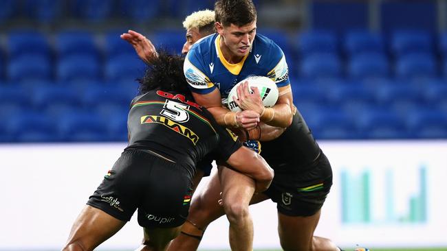 Sean Russell of the Eels is tackled in a rounds game between the rivals.