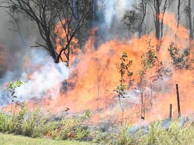 Bushfire in scrub at the end of Searle St in Maryborough. Firefighters backburn long grass behind the Ergon depot to contain the fire.