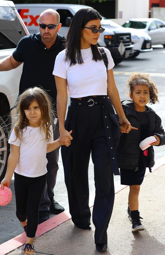 Kourtney Kardashian, centre, with her daughter Penelope Disick (left) and niece North West. Picture: Splash 