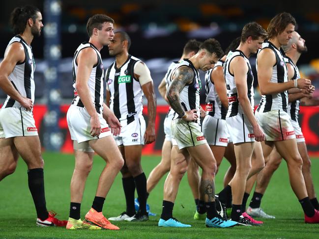 The Magpies trudge off the ground after their horrible night in Brisbane.