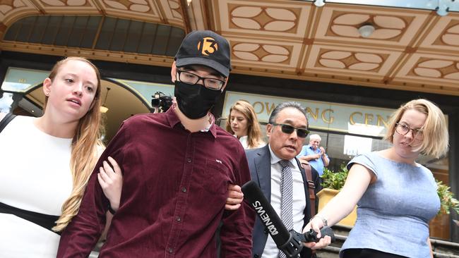 Yi Zheng (second left) leaves the Downing Centre Court in Sydney after being sentenced. Picture: AAP