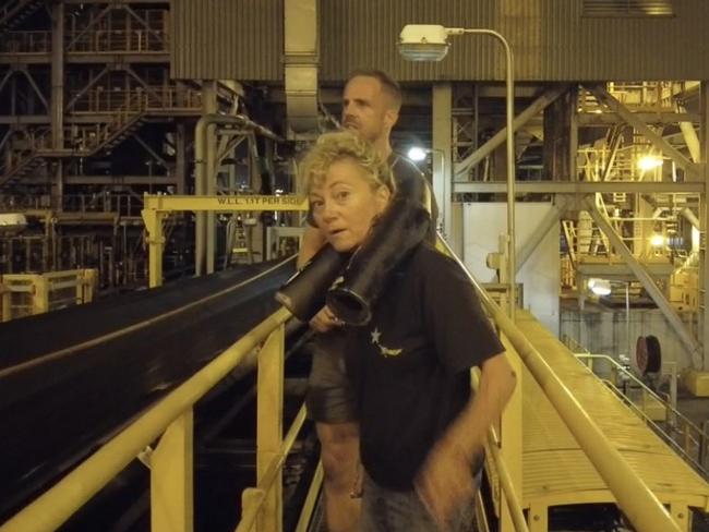 Kyle Magee (behind) and Juliet Lamont broke into the Hay Point Coal Terminal and chained themselves to the conveyor belts to protest inadequate emission targets as a part of Frontline Action on Coal's movement, October 25, 2021. Picture: Contributed