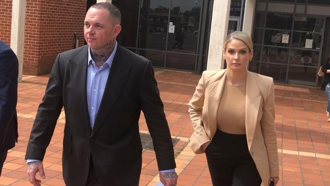 Monstr Clothing founder and accused bikie Shane Ross (centre), of Coomera, 36, and wife Alexandra outside Campbelltown Local Court where he was convicted over a sophisticated luxury car fraud syndicate.